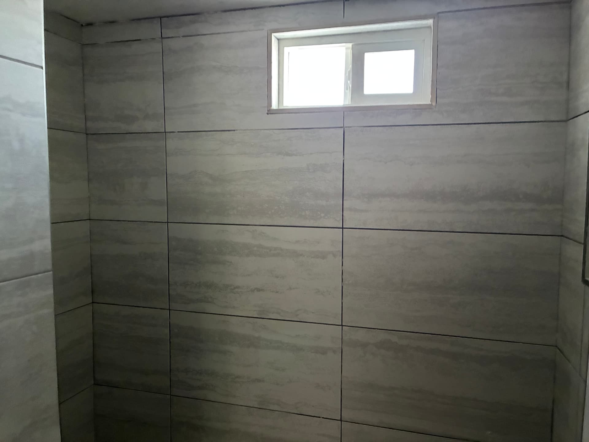 Full shower wall tile in large-format stone look — Brownsville, TX